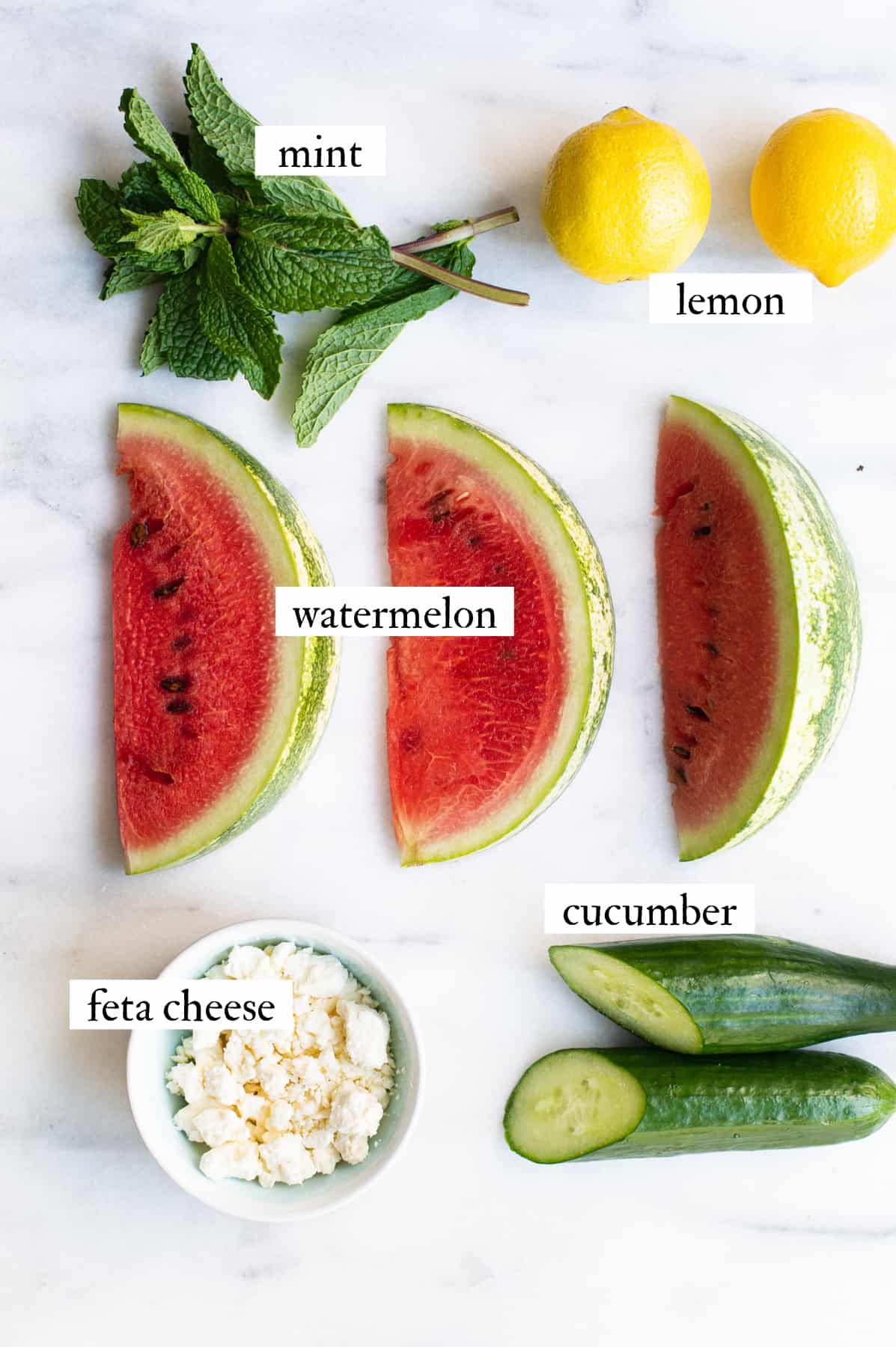 watermelon salad ingredients on white marble