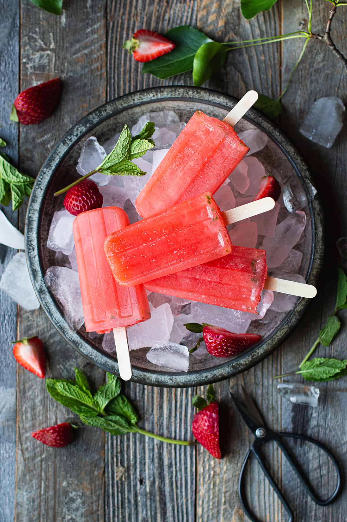 top view of stacked strawberry mint popsicles on ice
