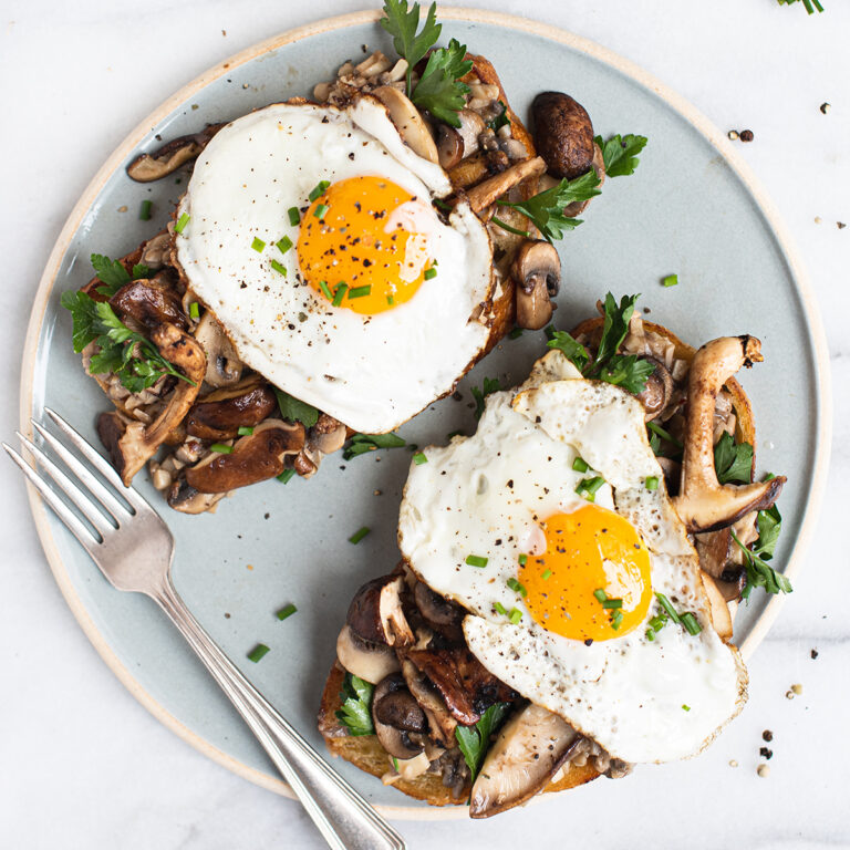 two mushroom toasts, topped with fried egg