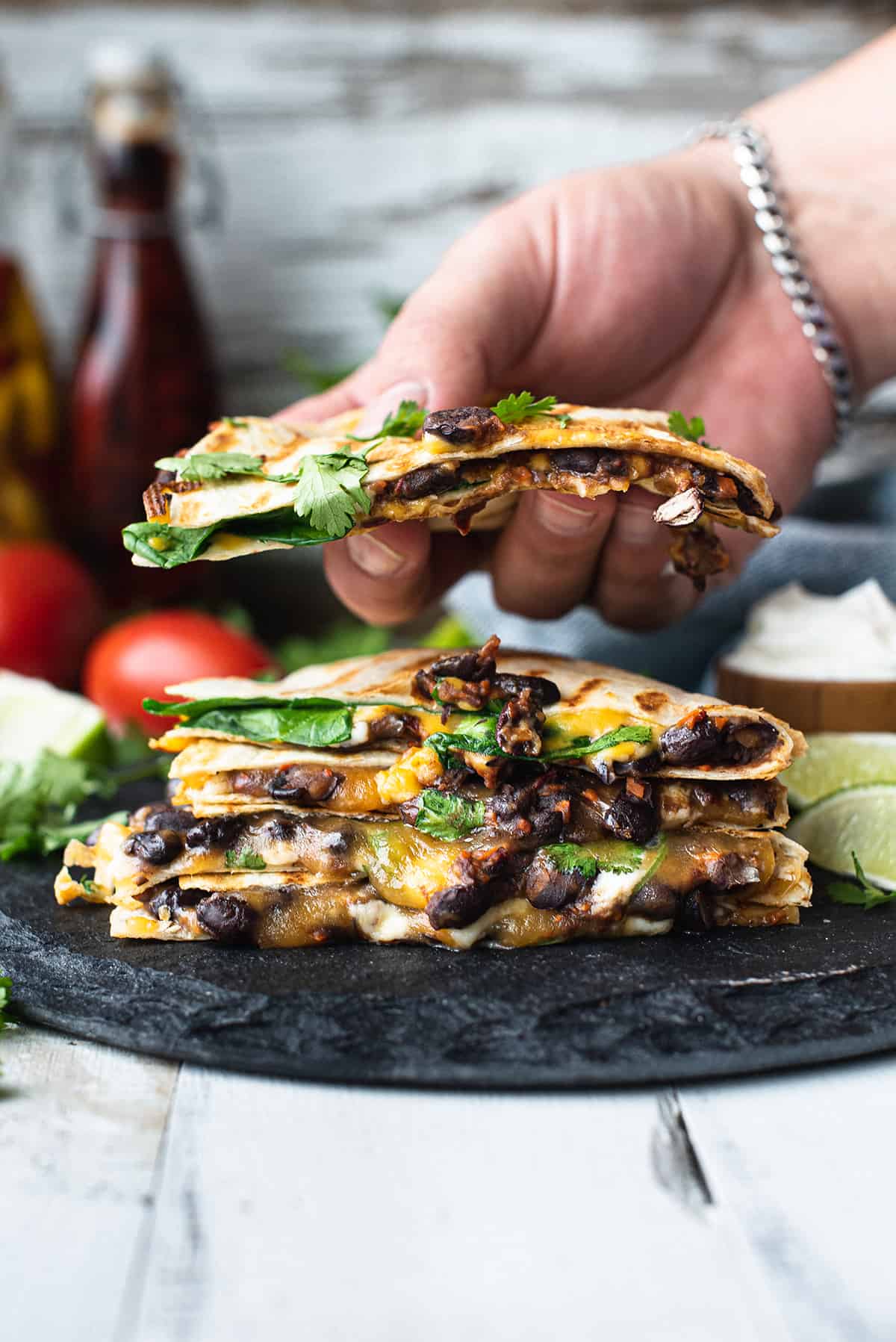stacked quesadillas with hand picking one up