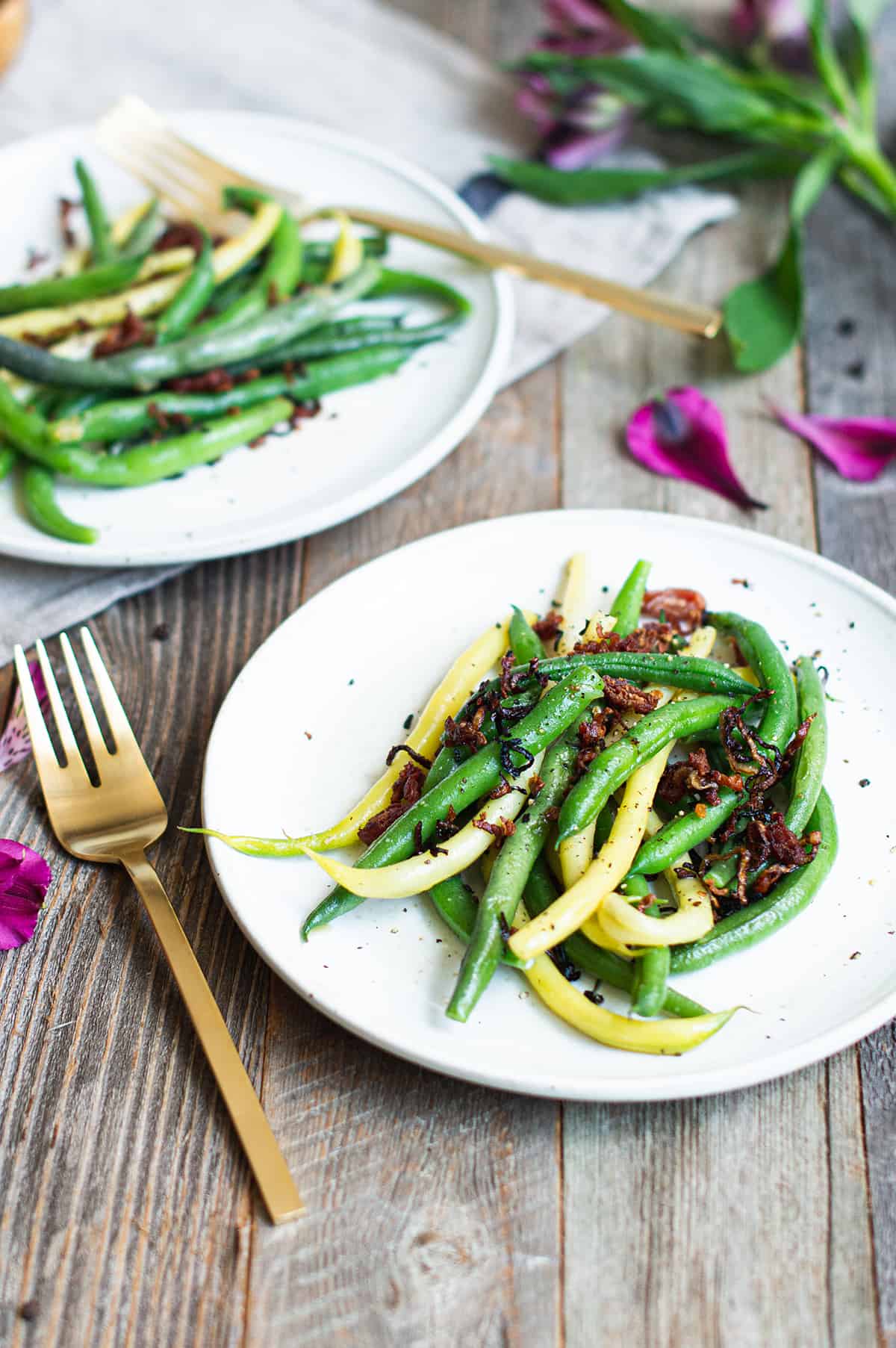 green & yellow beans on white plate with gold fork 
