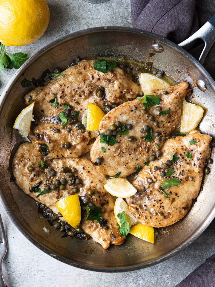 chicken piccata in pan with lemons