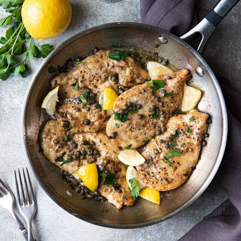 chicken piccata in pan with lemons