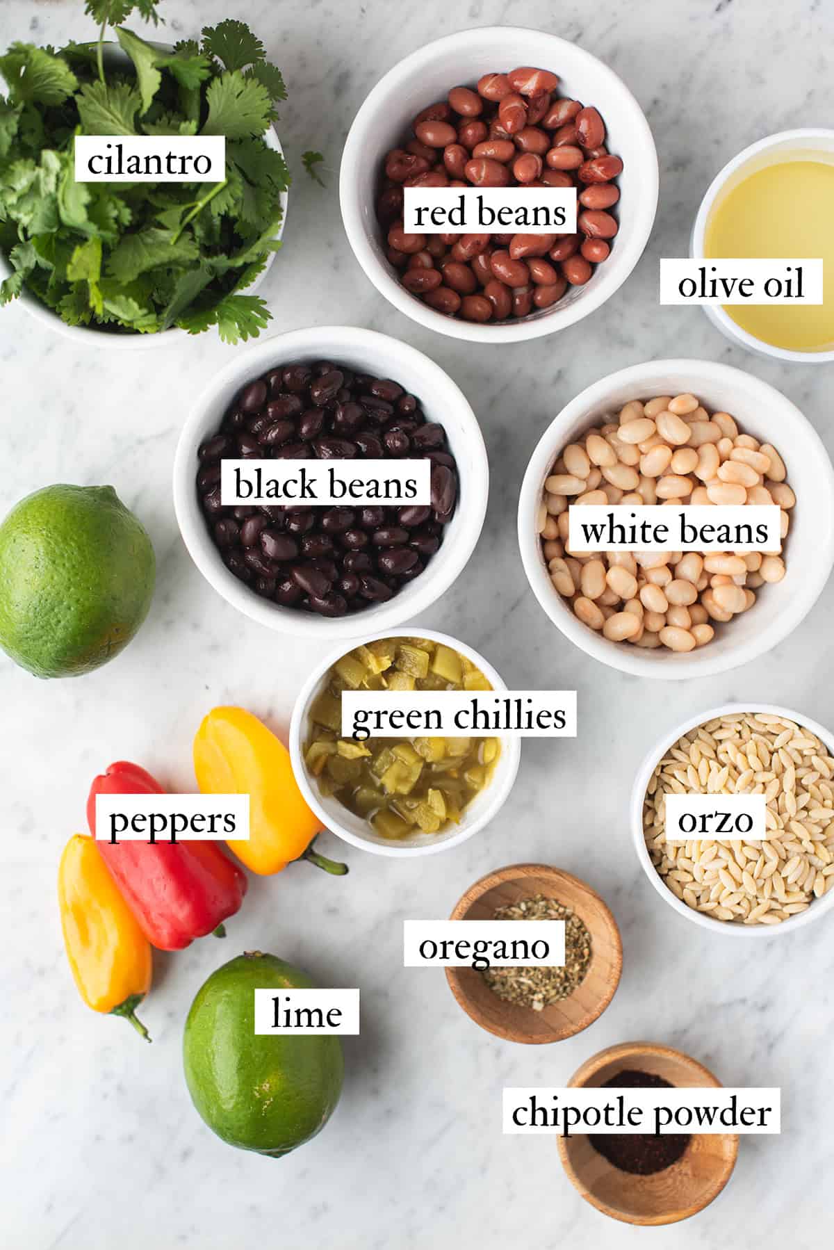 ingredients for southwestern bean salad including mixed beans, orzo, peppers, lime and cilantro