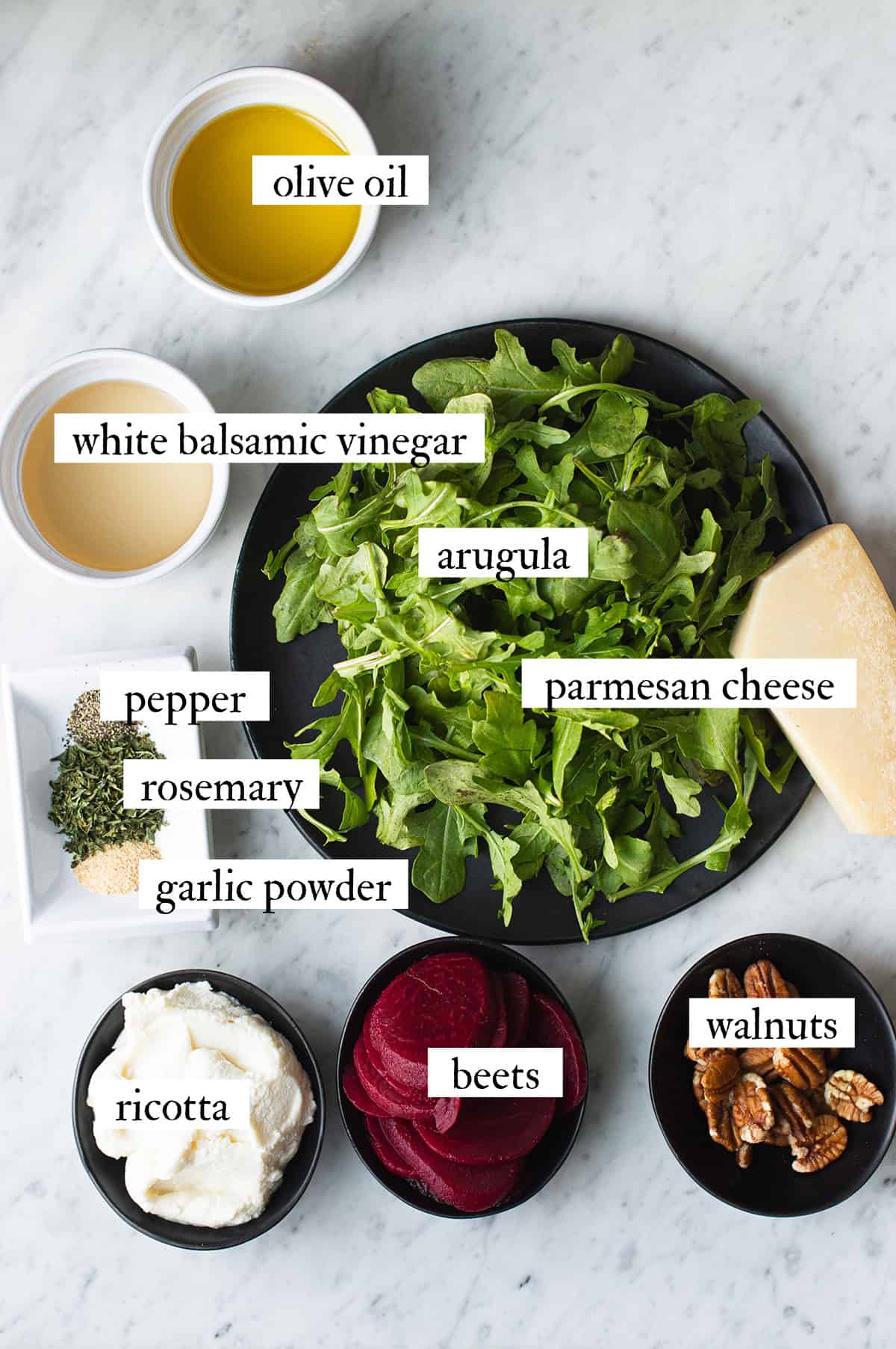 ingredients for arugula beet salad with herbed ricotta, spread out on white countertop
