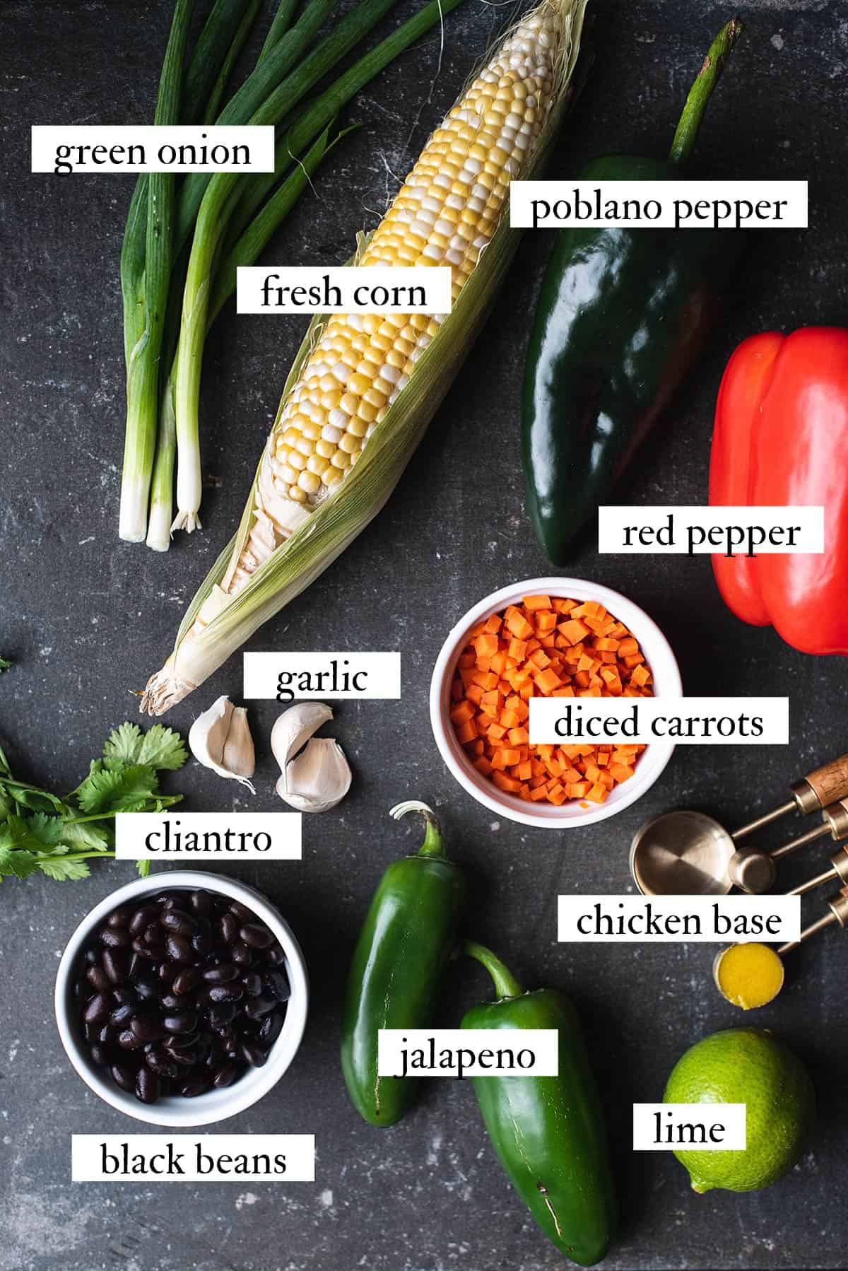 black bean soup ingredients spread out on black countertop
