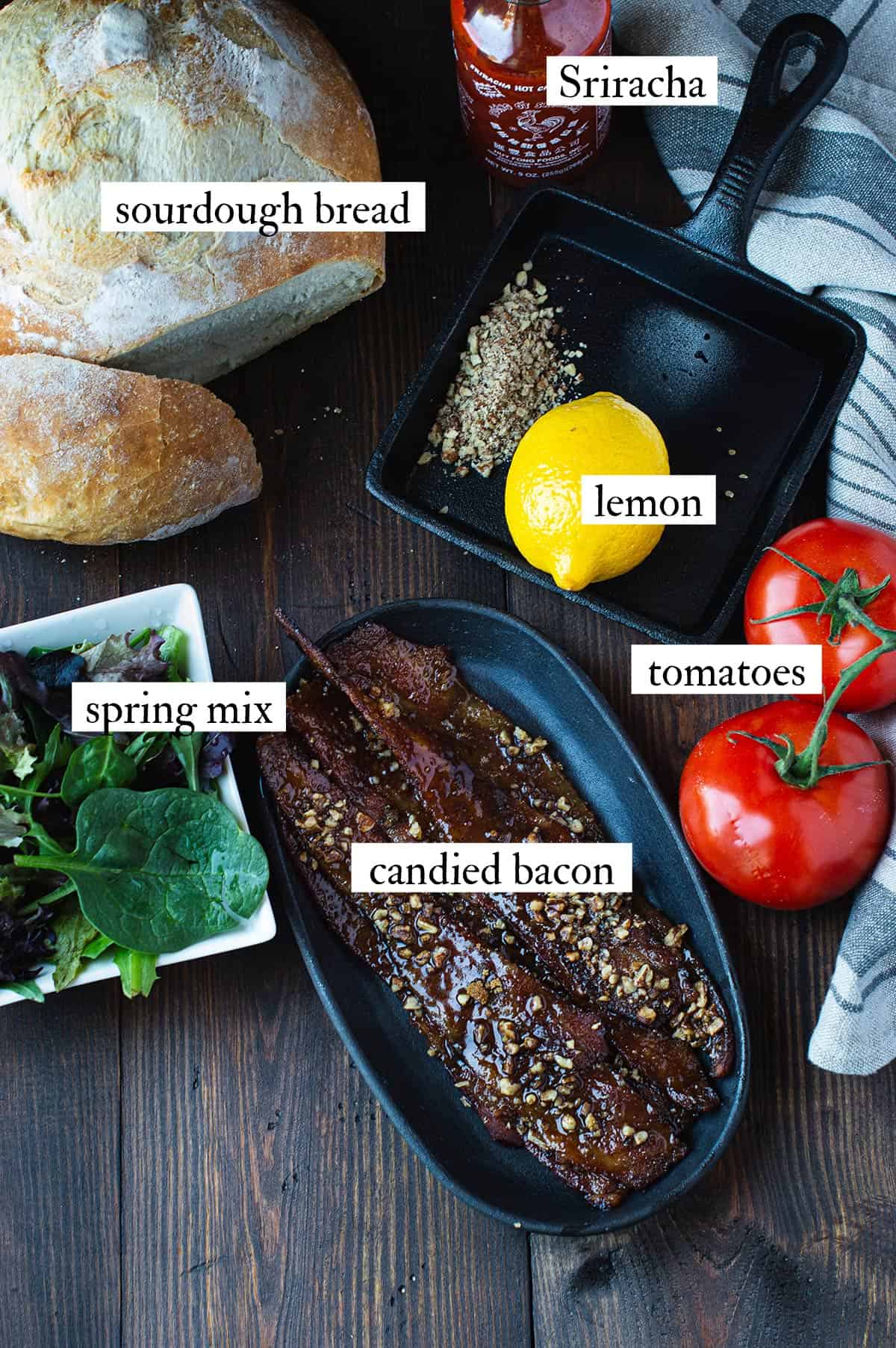 ingredients for BLT sandwich with candied bacon including candied bacon, sourdough bread, lettuce, tomatoes, and Sriracha aioli ingredients