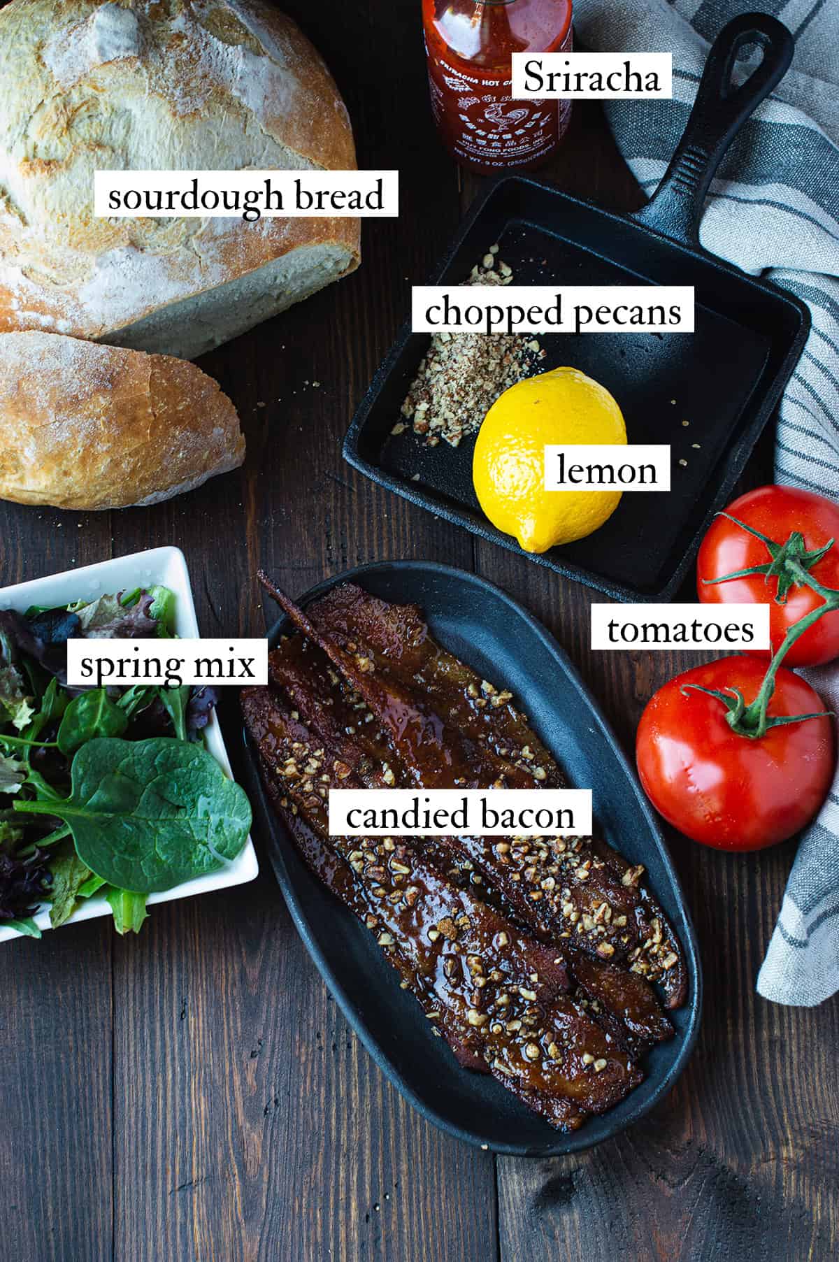 ingredients for BLT sandwich with candied bacon including candied bacon, sourdough bread, lettuce, tomatoes, and Sriracha aioli ingredients