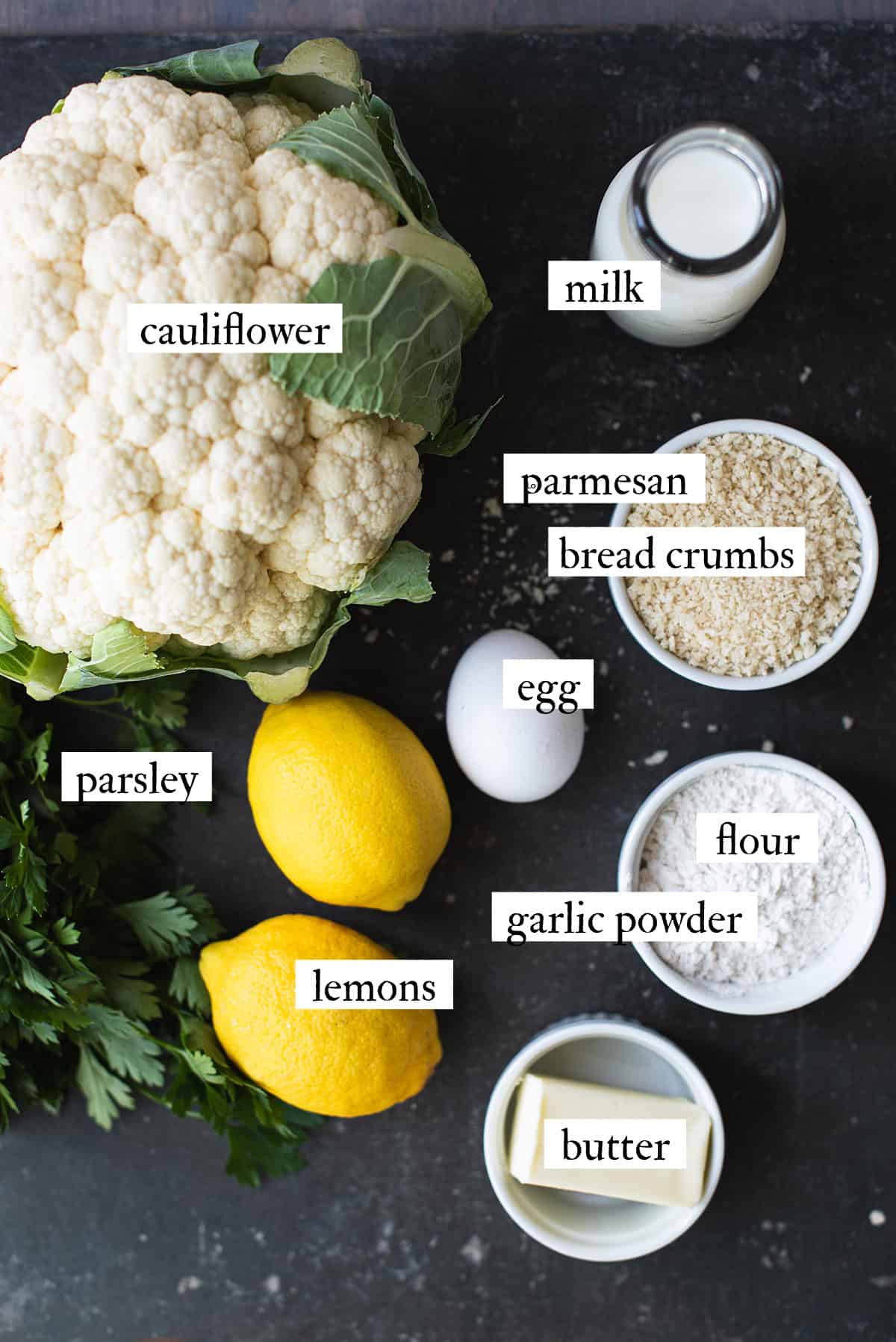 ingredients for lemon parmesan cauliflower bites including cauliflower, parmesan, breadcrumbs, and lemon