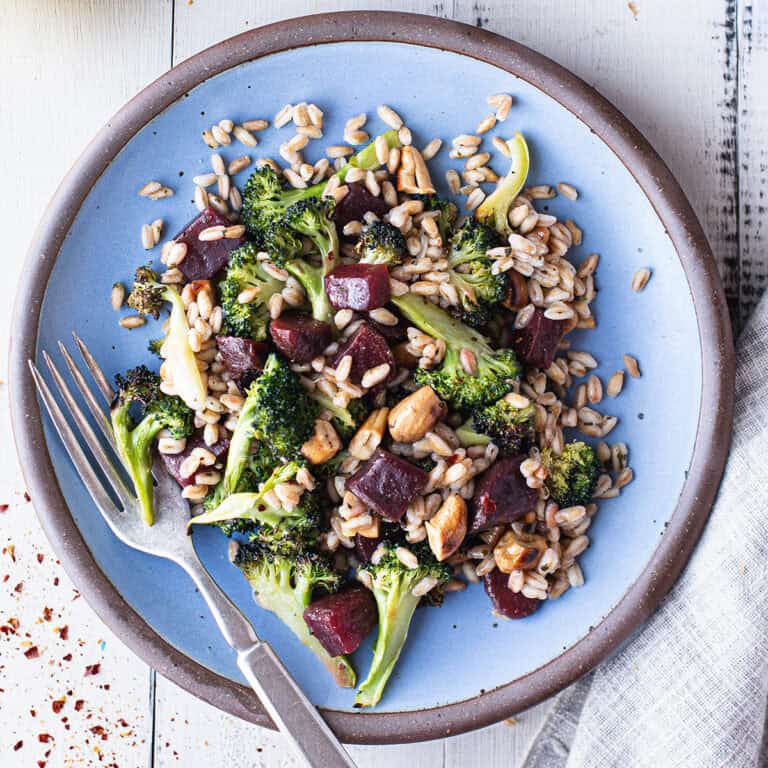 broccoli salad served on blue plate with fork
