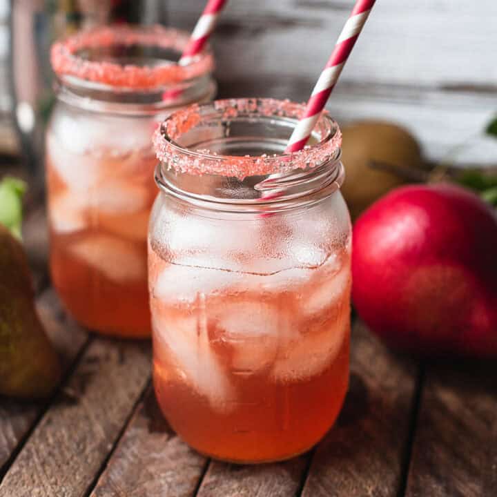 red fall vodka cocktails with sugar rim in mason jars with red striped straws