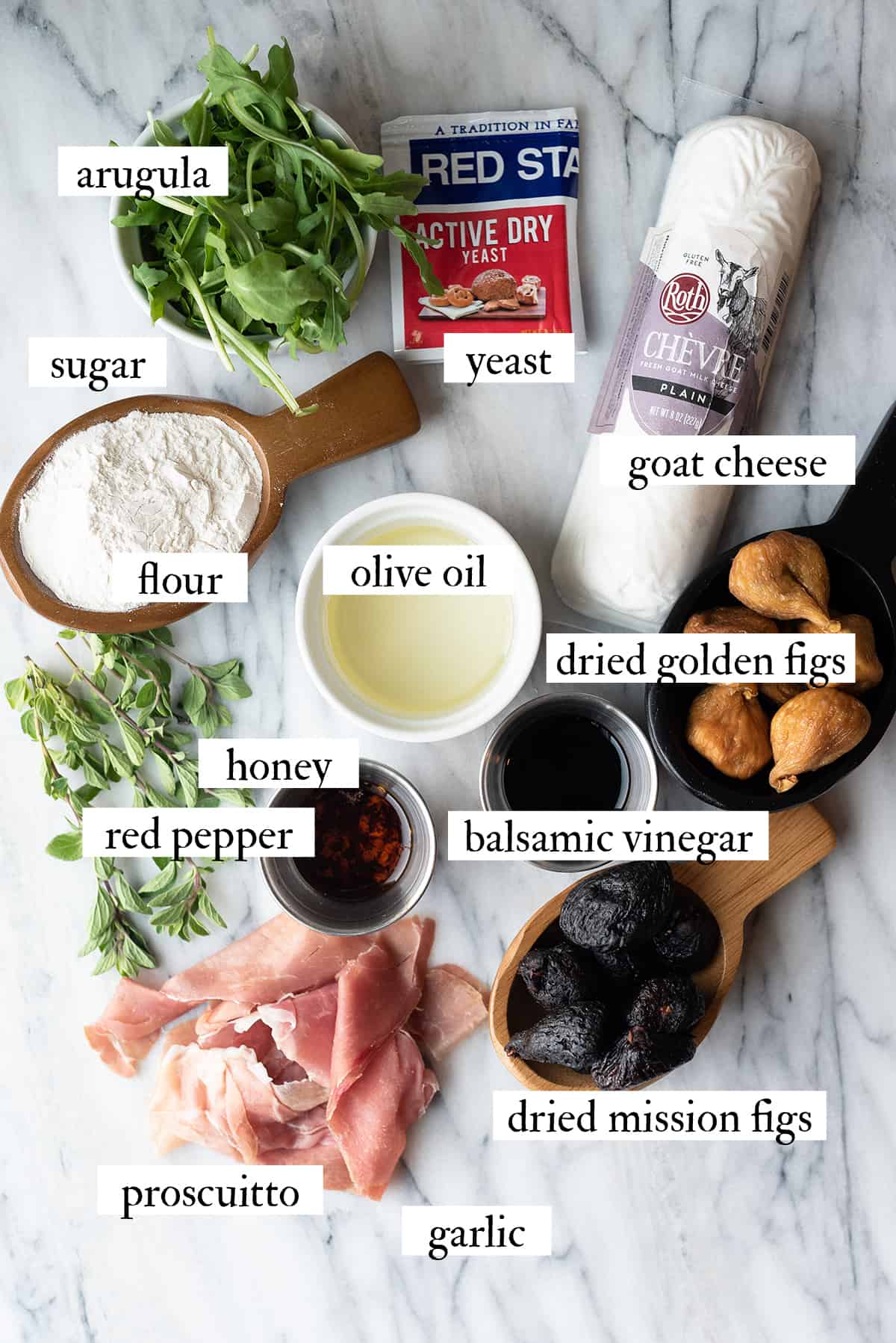 ingredients for fig pizza on white marble counter
