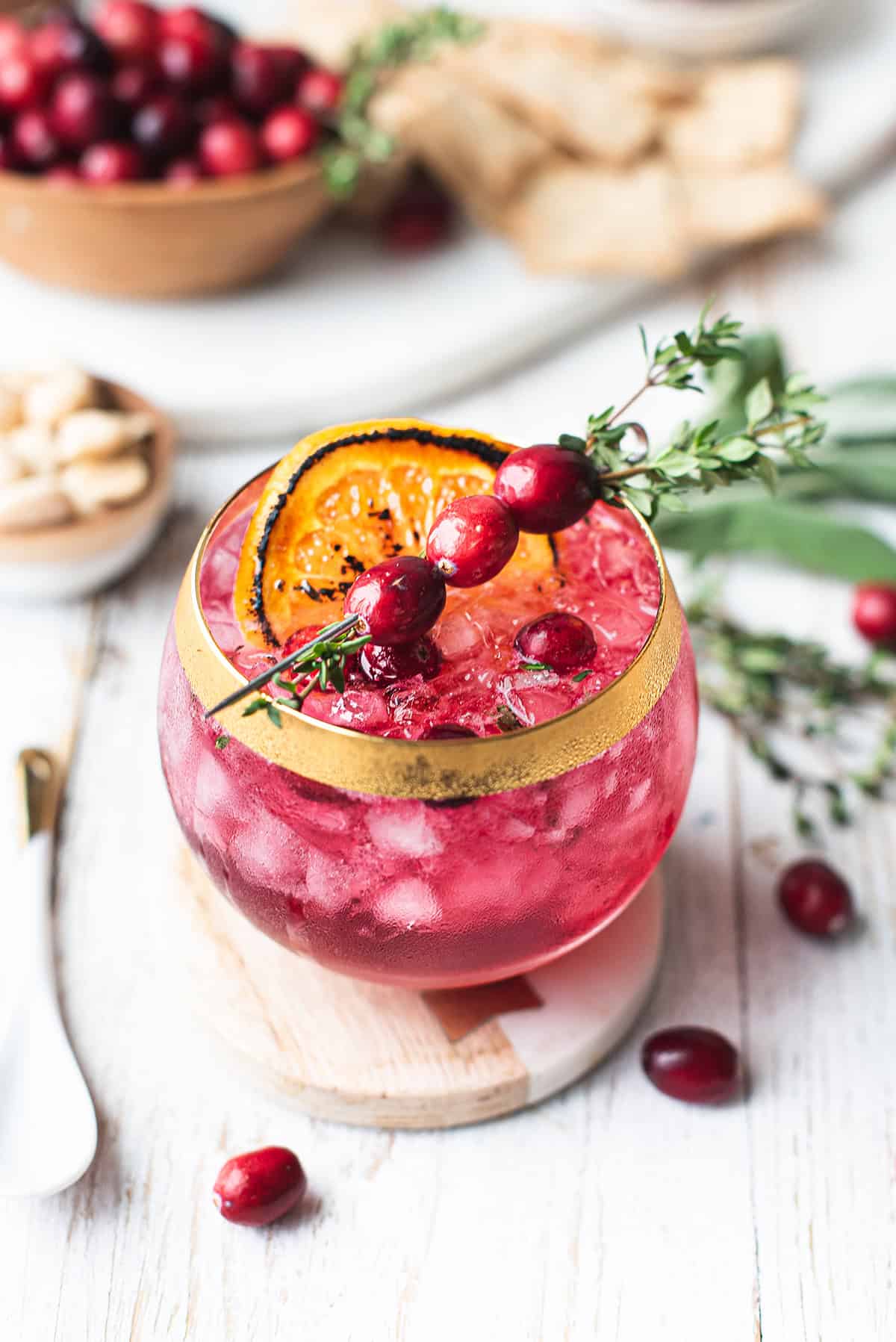 festive empress fizz with cranberry garnish on table
