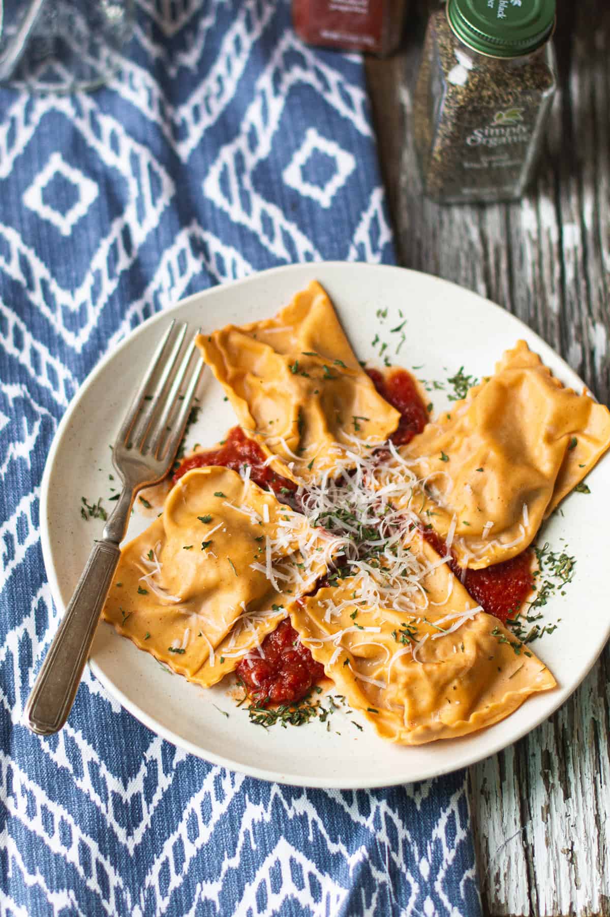 plated chorizo and ricotta ravioli served in tomato sauce with parmesan