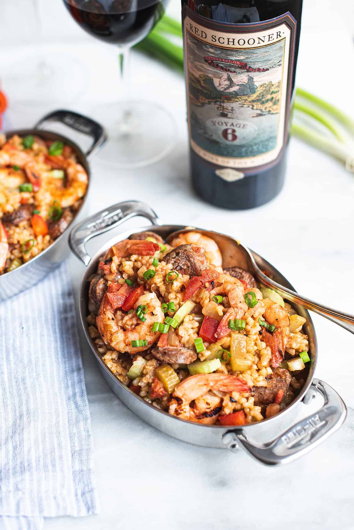 serving pan of creole style shrimp jambalaya with red schooner wine