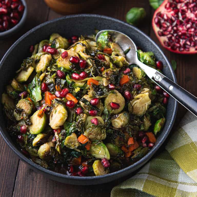 bowl of maple roasted Brussels sprouts with serving spoon