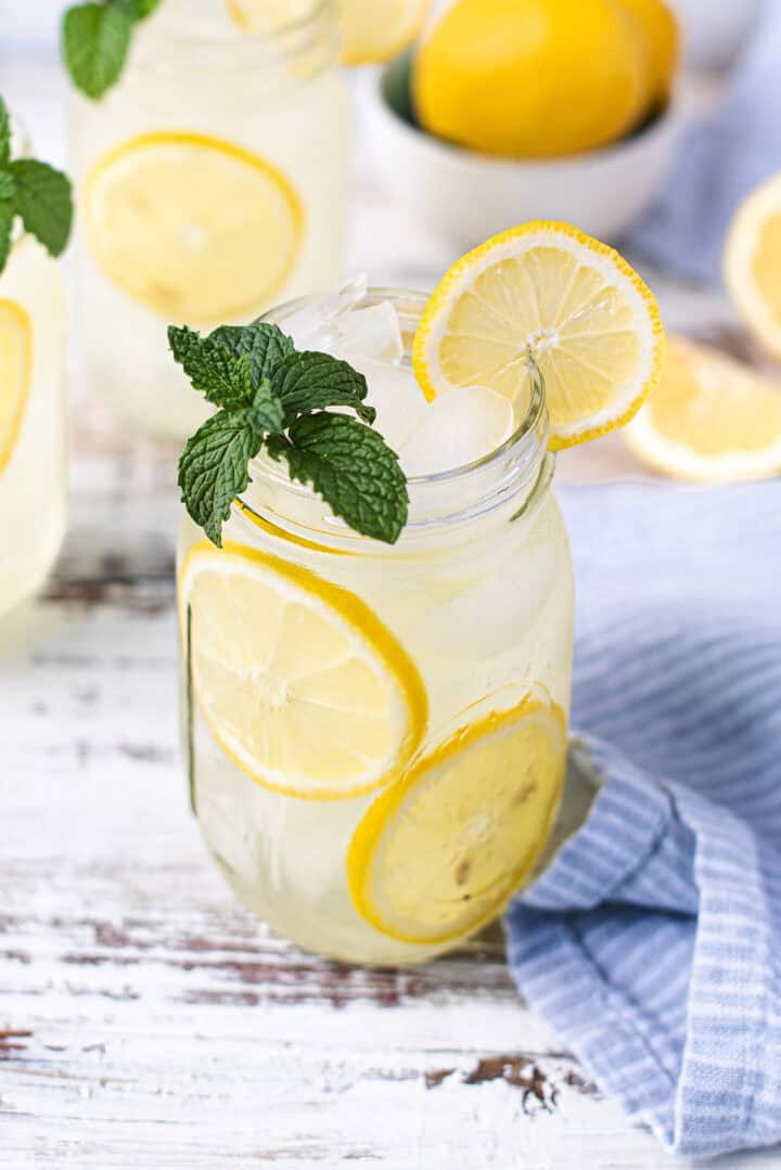 mint lemonade in mason jar with lemon slices and mint garnish