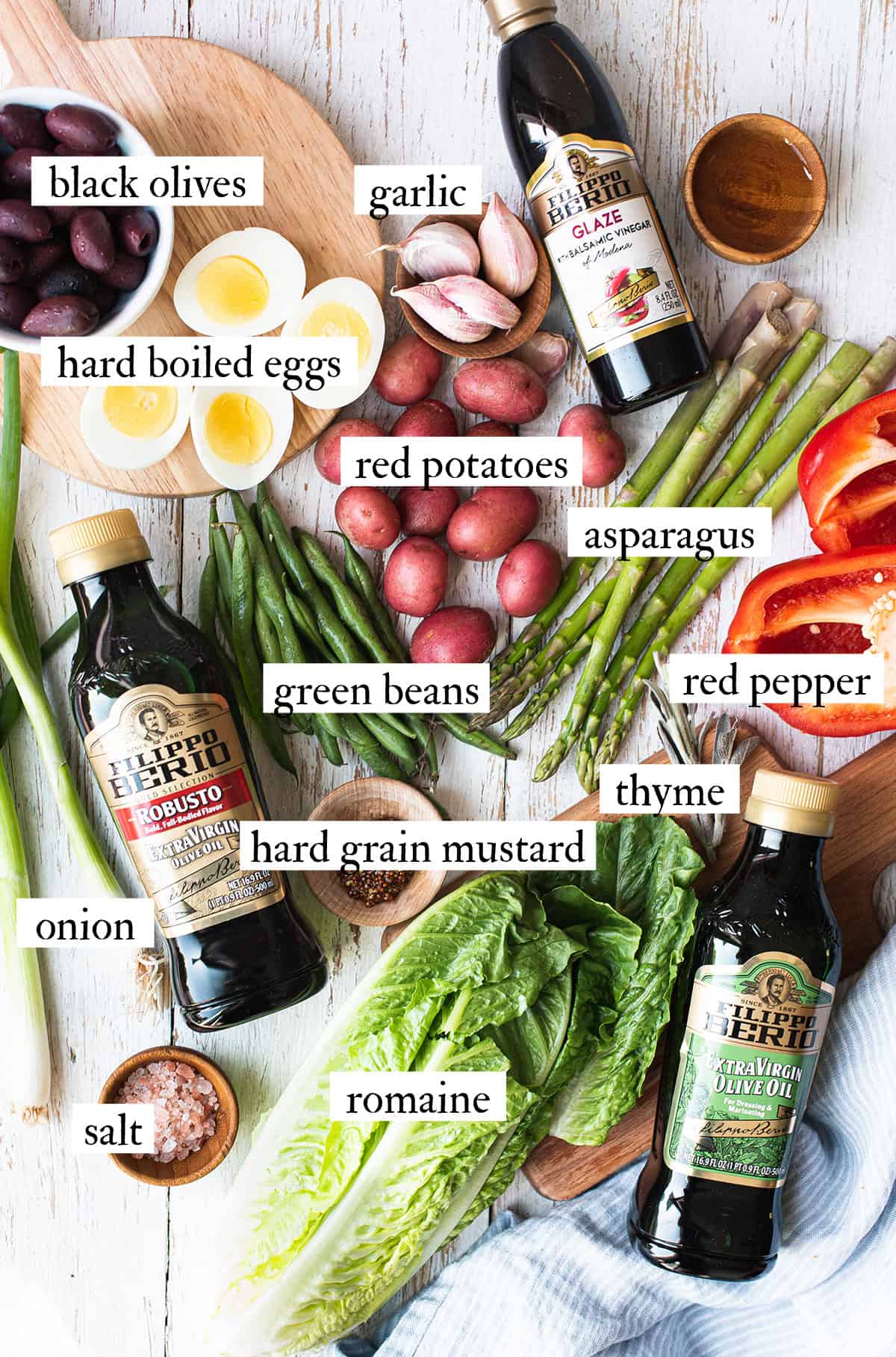 ingredients for olive oil poached cod salad spread out on a table