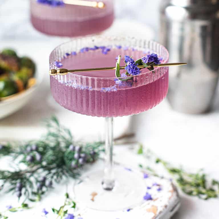 sparkling purple gin cocktail in coupe glass made with Empress 1908 gin