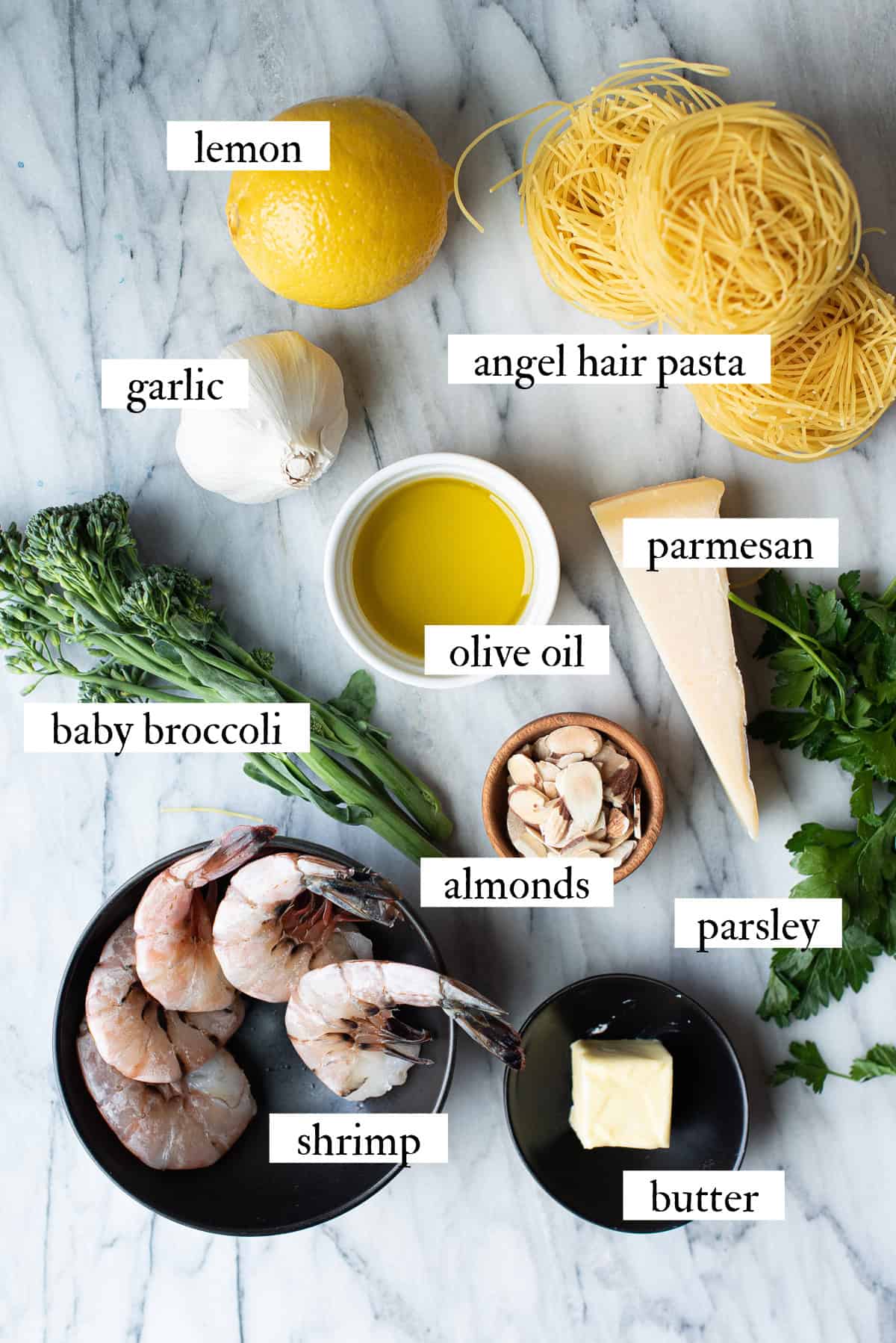 lemony shrimp pasta ingredients on marble surface