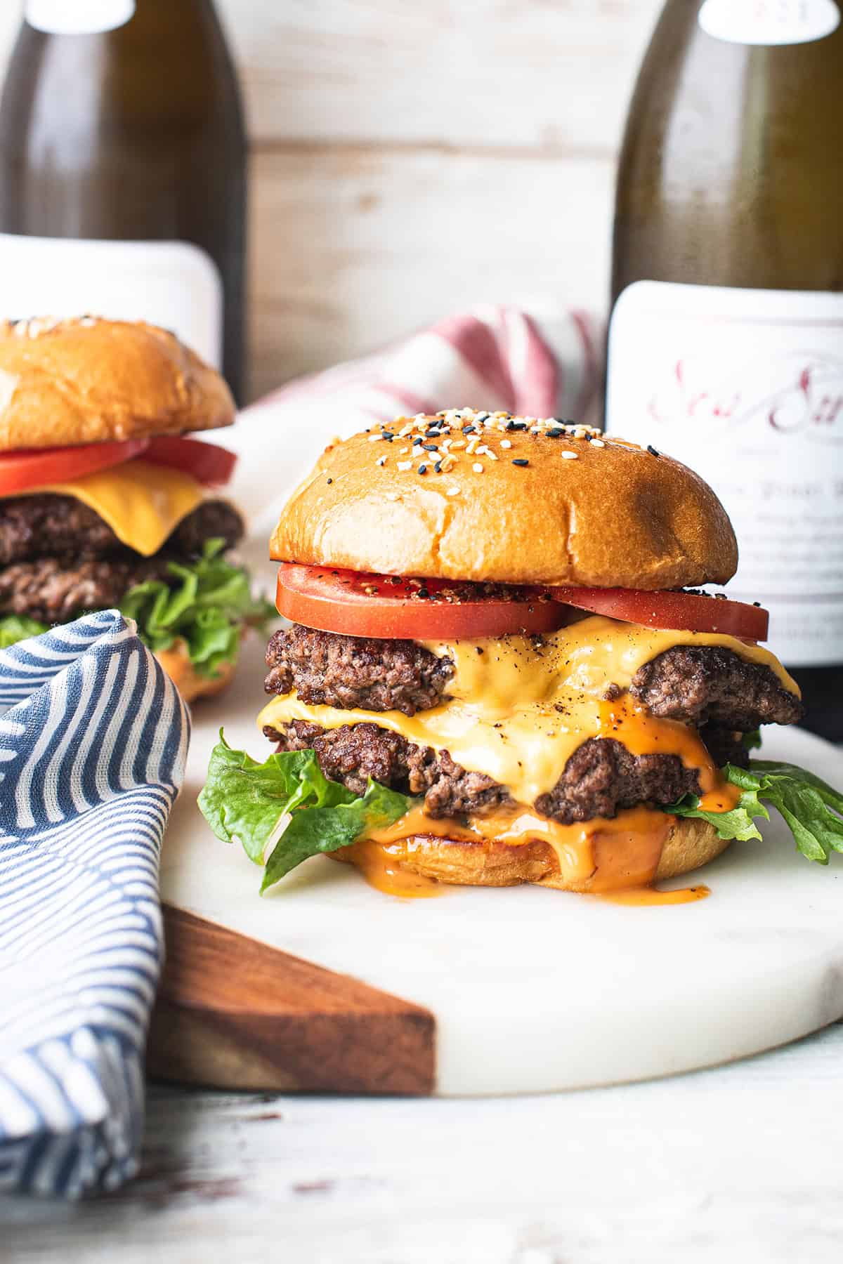 two homemade smash burgers with special sauce served on a marble board