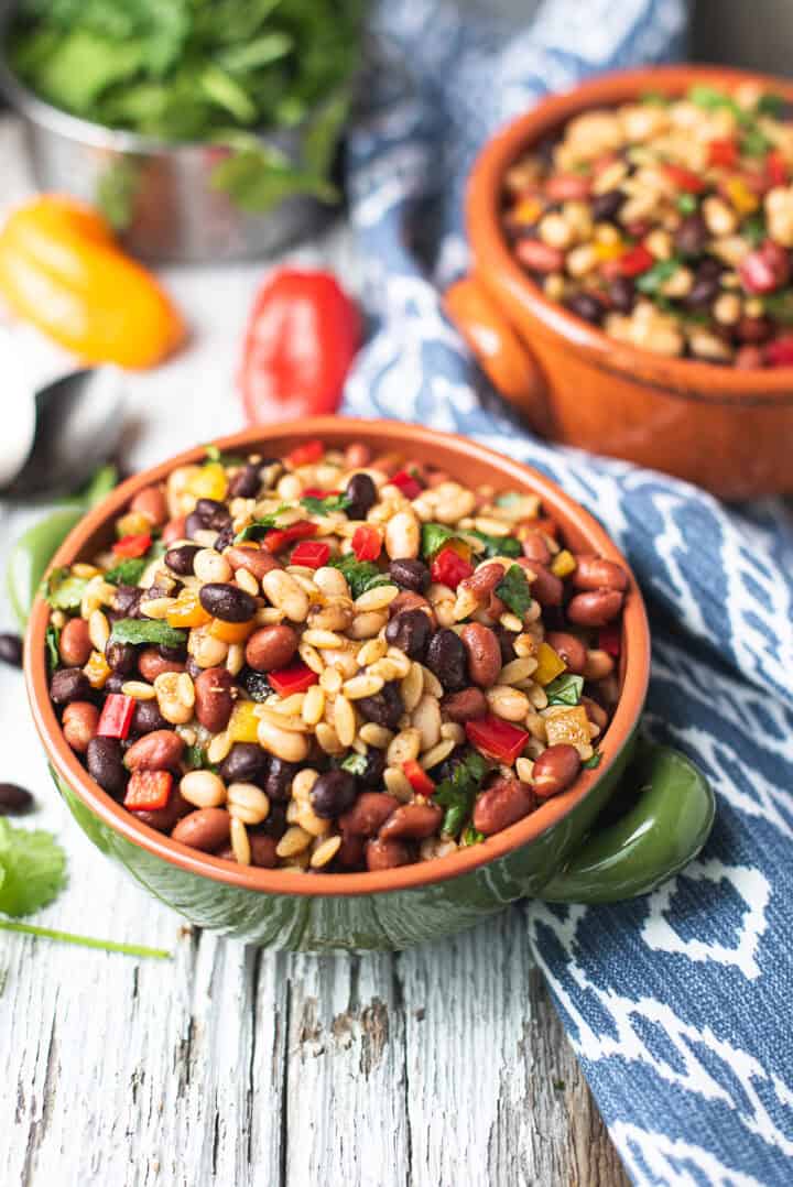 close-up of a Southwestern bean salad with orzo, lime dressing, and fresh vegetables