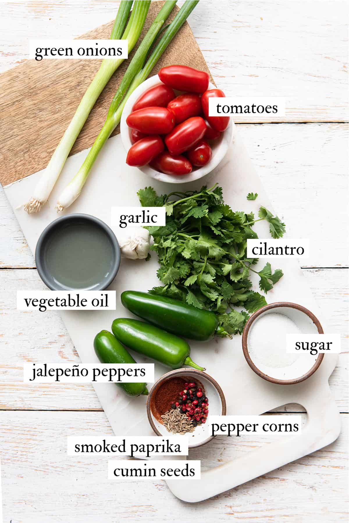 Ingredients for tomato jalapeno jam on a cutting board.