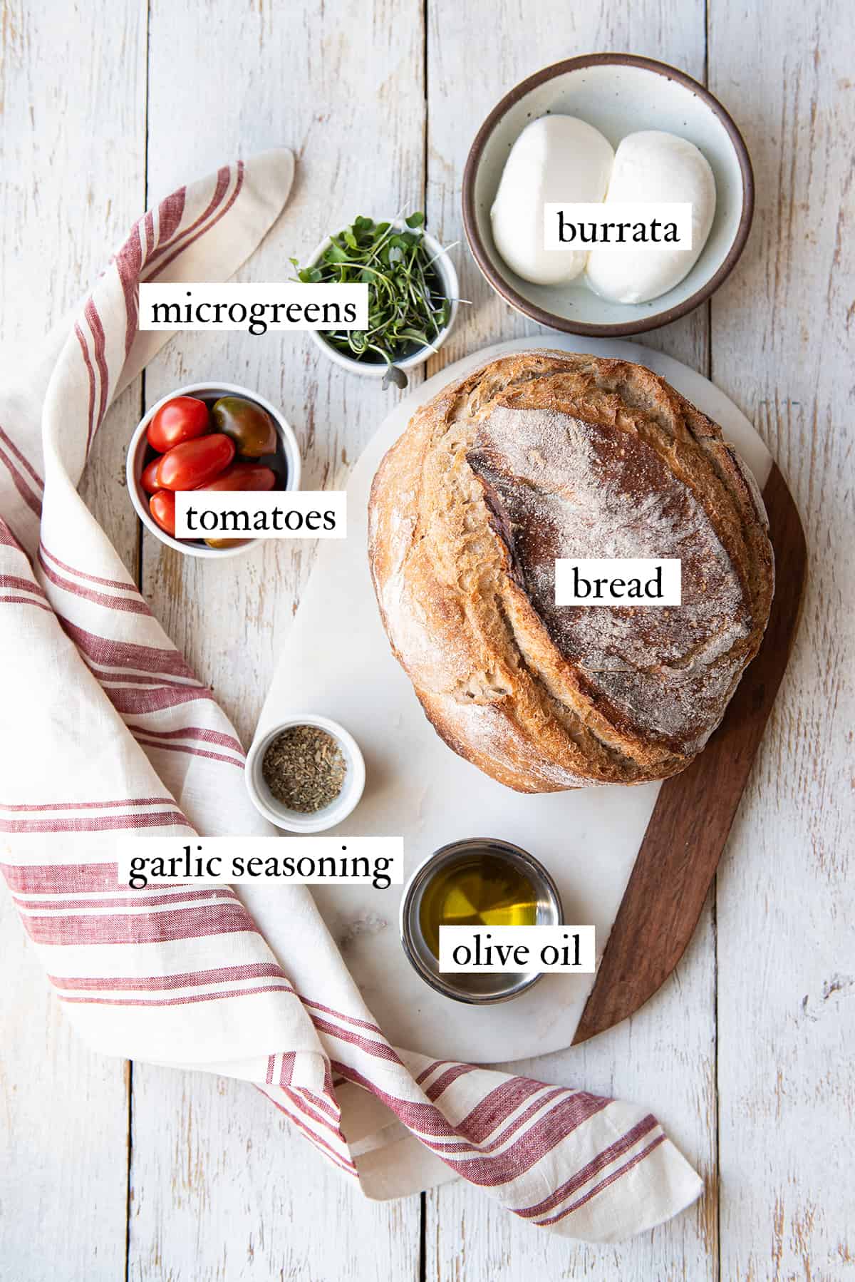 ingredients for burrata toast on white table