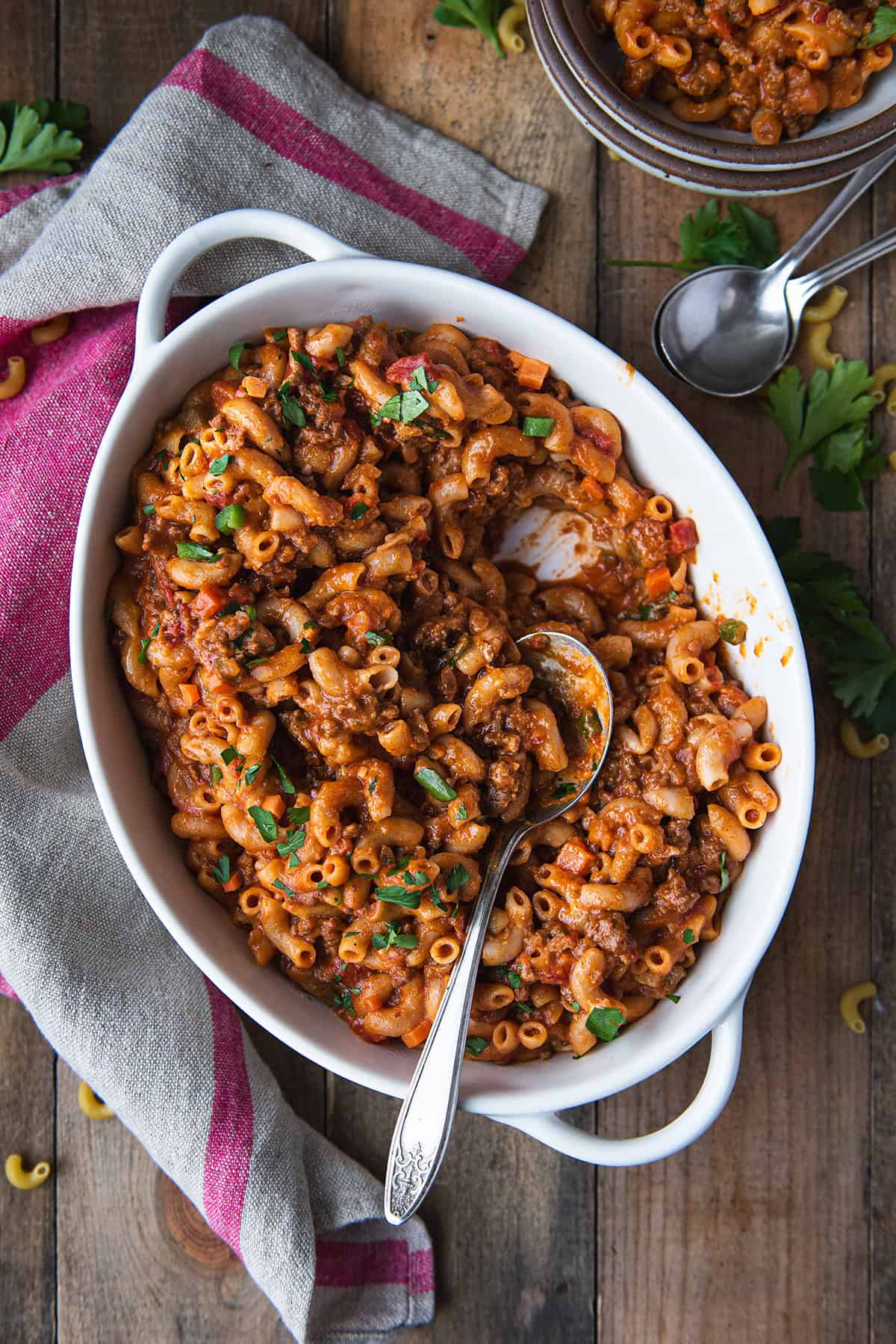 classic homemade goulash in white serving dish with spoon