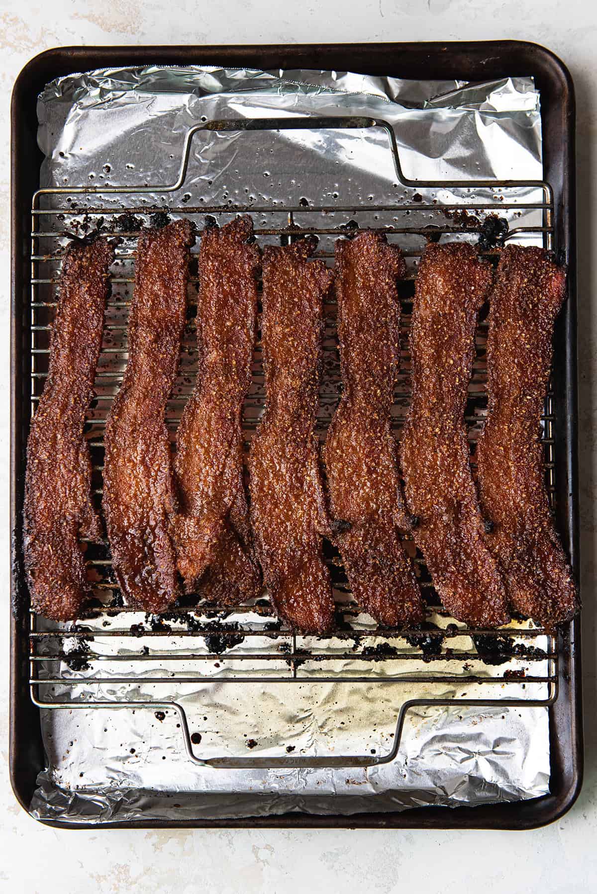 candied bacon cooling on a wire rack after baking